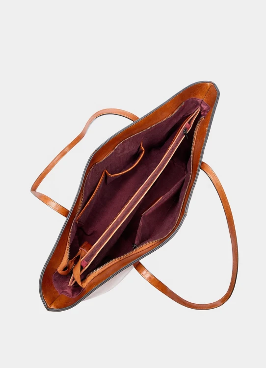Duża skórzana torba typu shopper w kolorze karmelowym z uchwytem na ramię i pojemnym wnętrzem. Widok wnętrza.