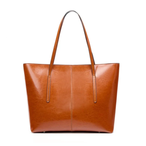 Duża skórzana torba typu shopper w kolorze karmelowym z uchwytem na ramię i pojemnym wnętrzem.